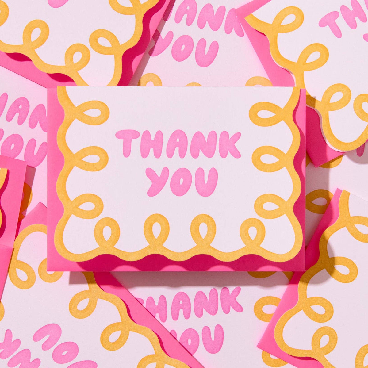 Pink and yellow 'Thank You' cards with decorative patterns.