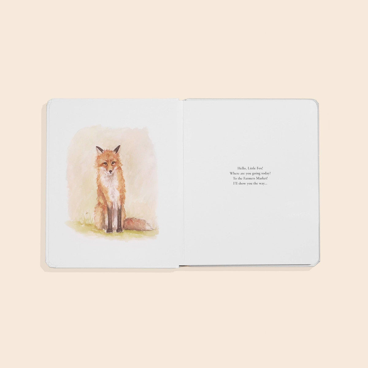 Open book with a fox illustration on a light beige background