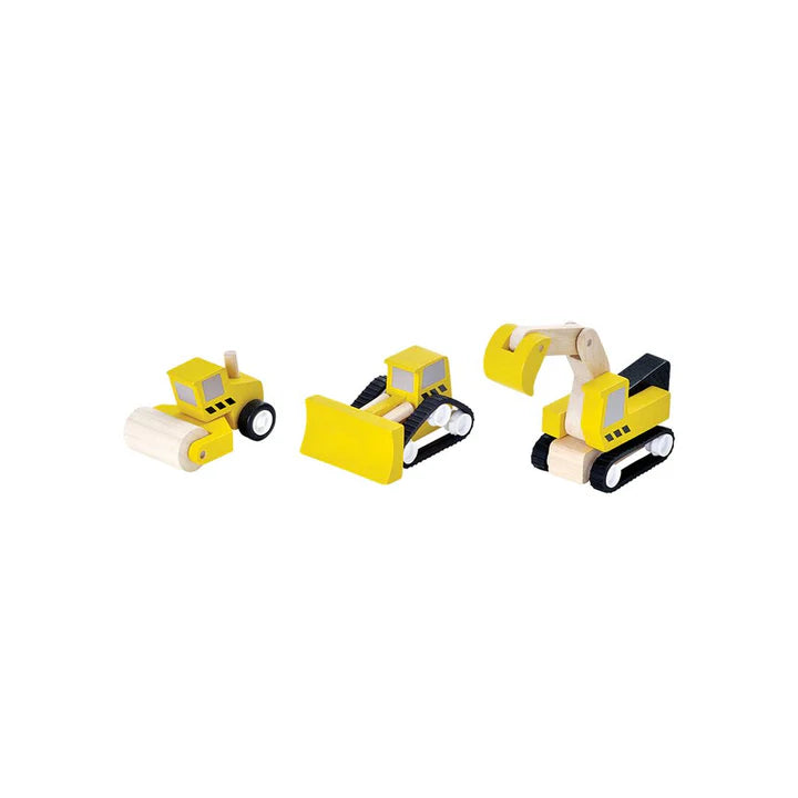 Set of three toy construction vehicles on a white background