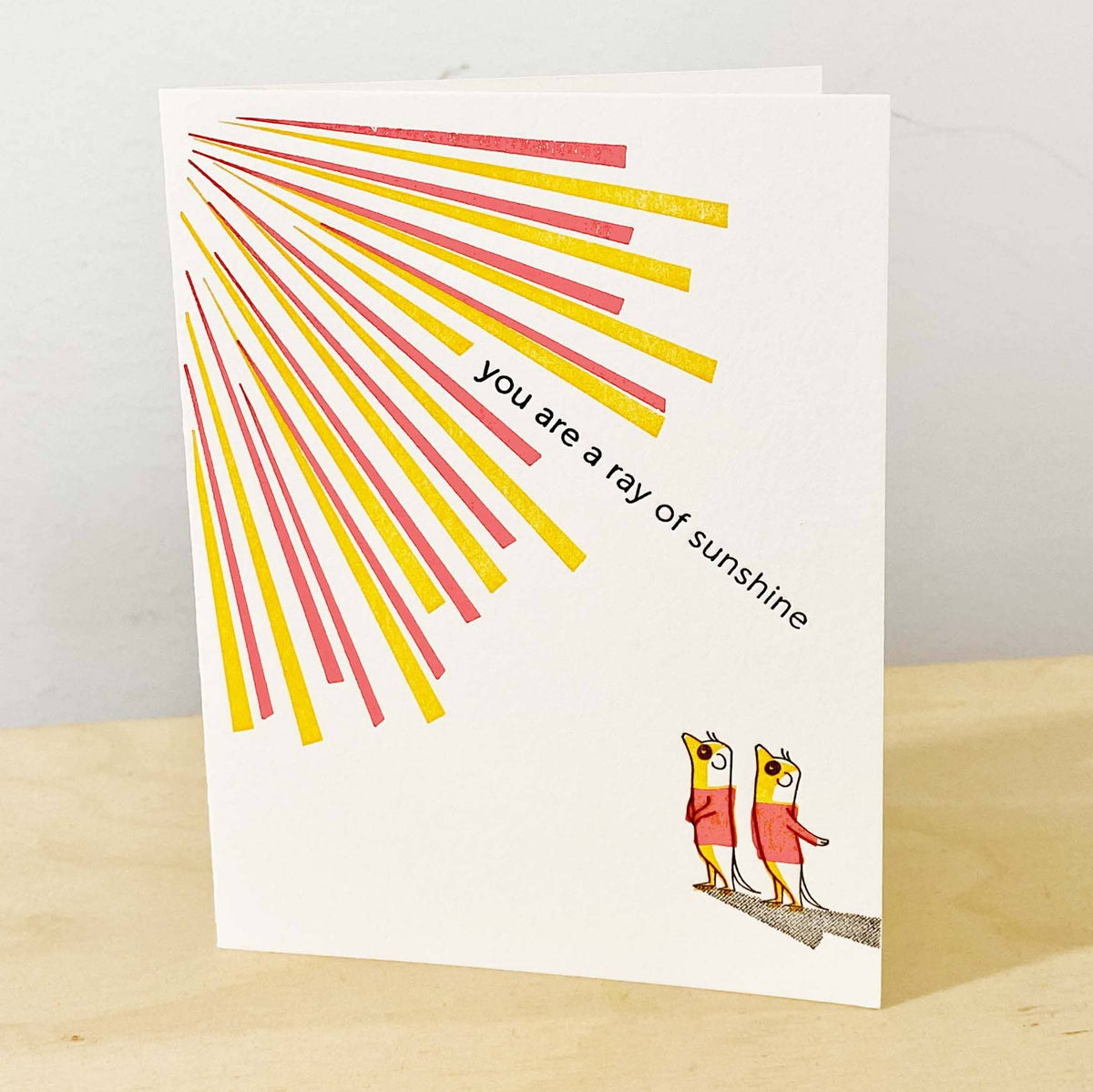 Greeting card with sunburst design and birds on a branch, featuring the text &#39;you are a ray of sunshine&#39;.