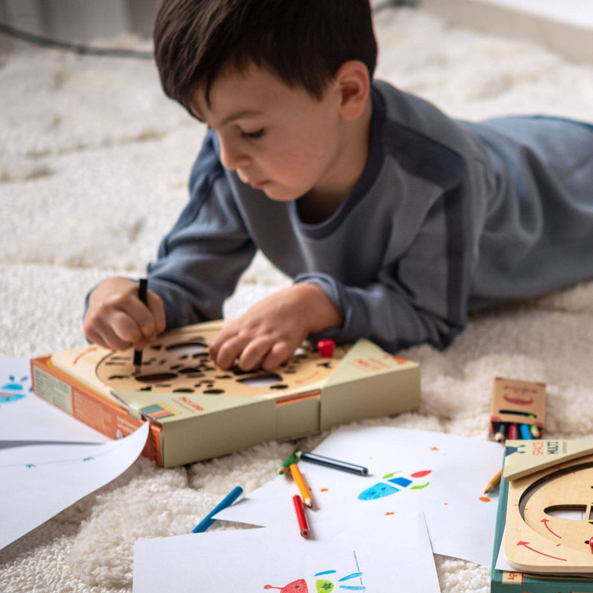 Child playing with a wooden art toy on a carpeted floor.