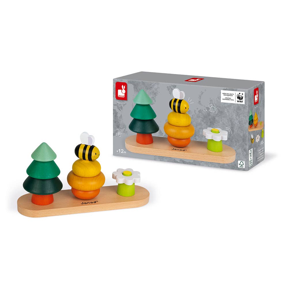 Wooden toy set with trees, flowers, and a bee on a wooden base, next to its packaging.