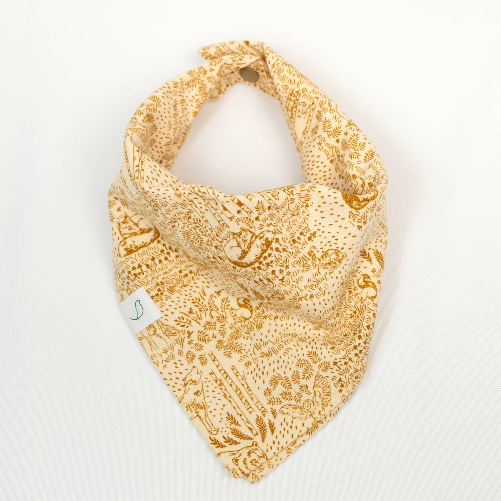 Yellow patterned bandana bib on a white background