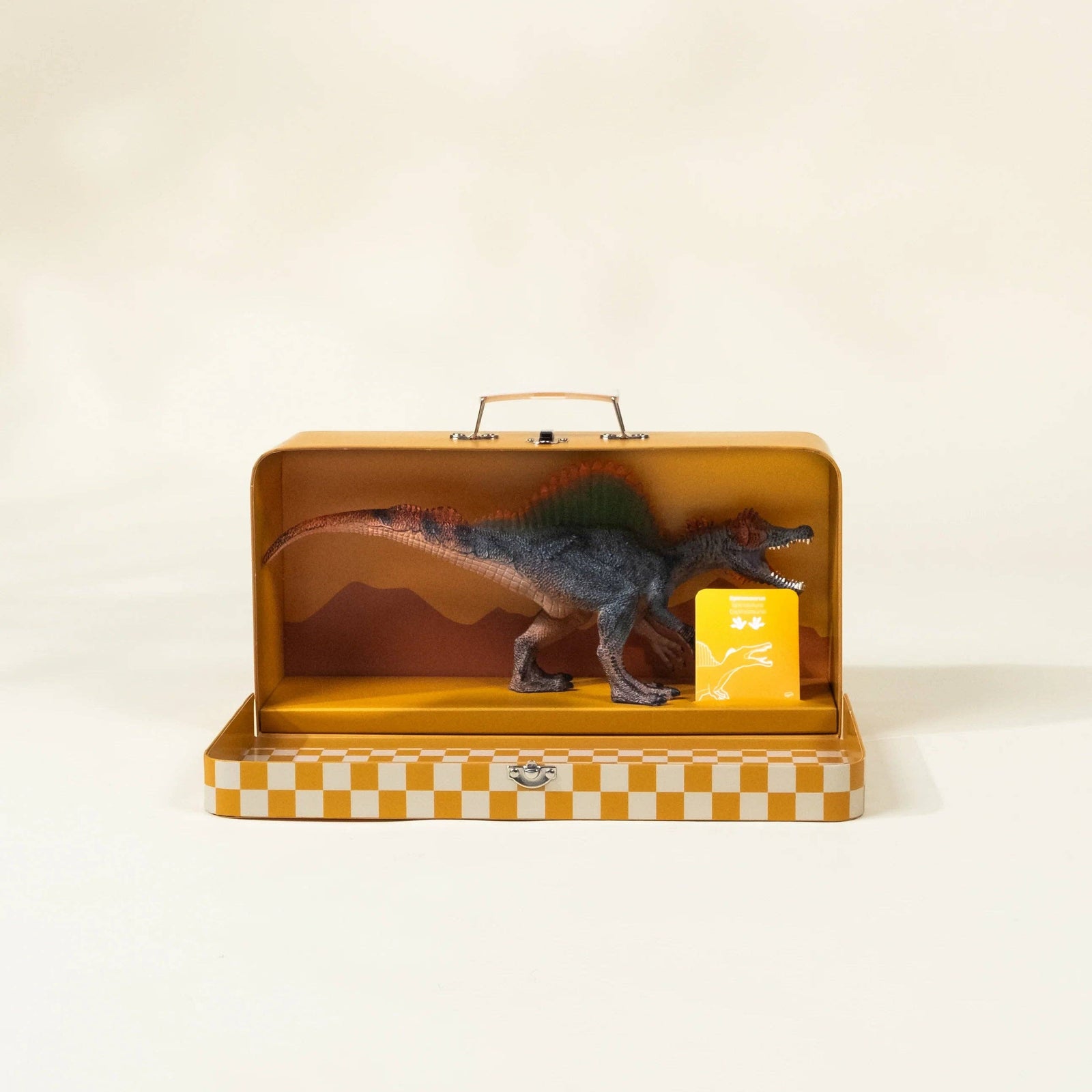 Yellow toy dinosaur box with a dinosaur illustration on a beige background