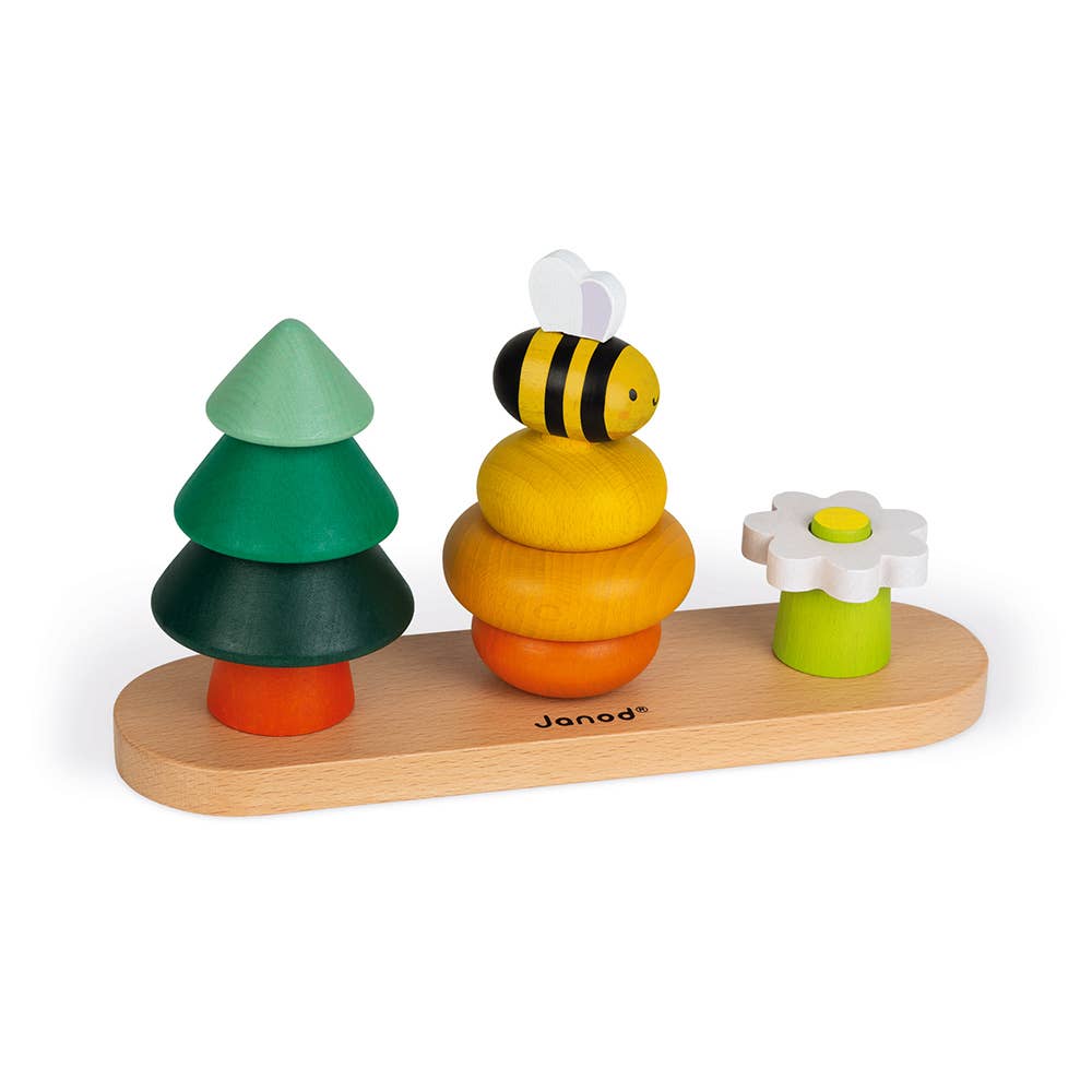 Wooden toy set with trees, a bee, and a flower on a white background