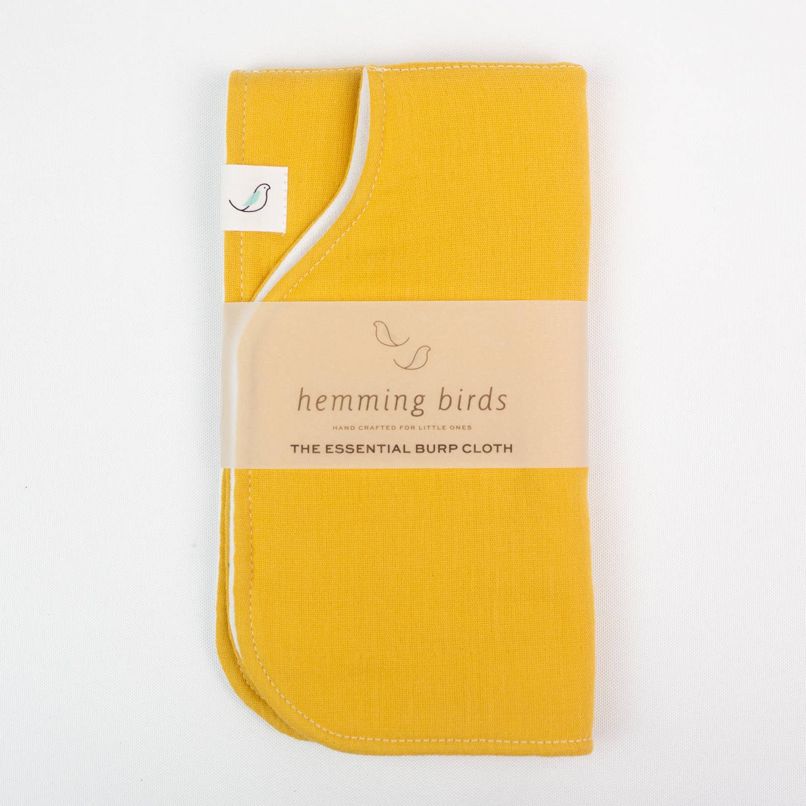 Yellow burp cloth with 'hemming birds' label on a white background
