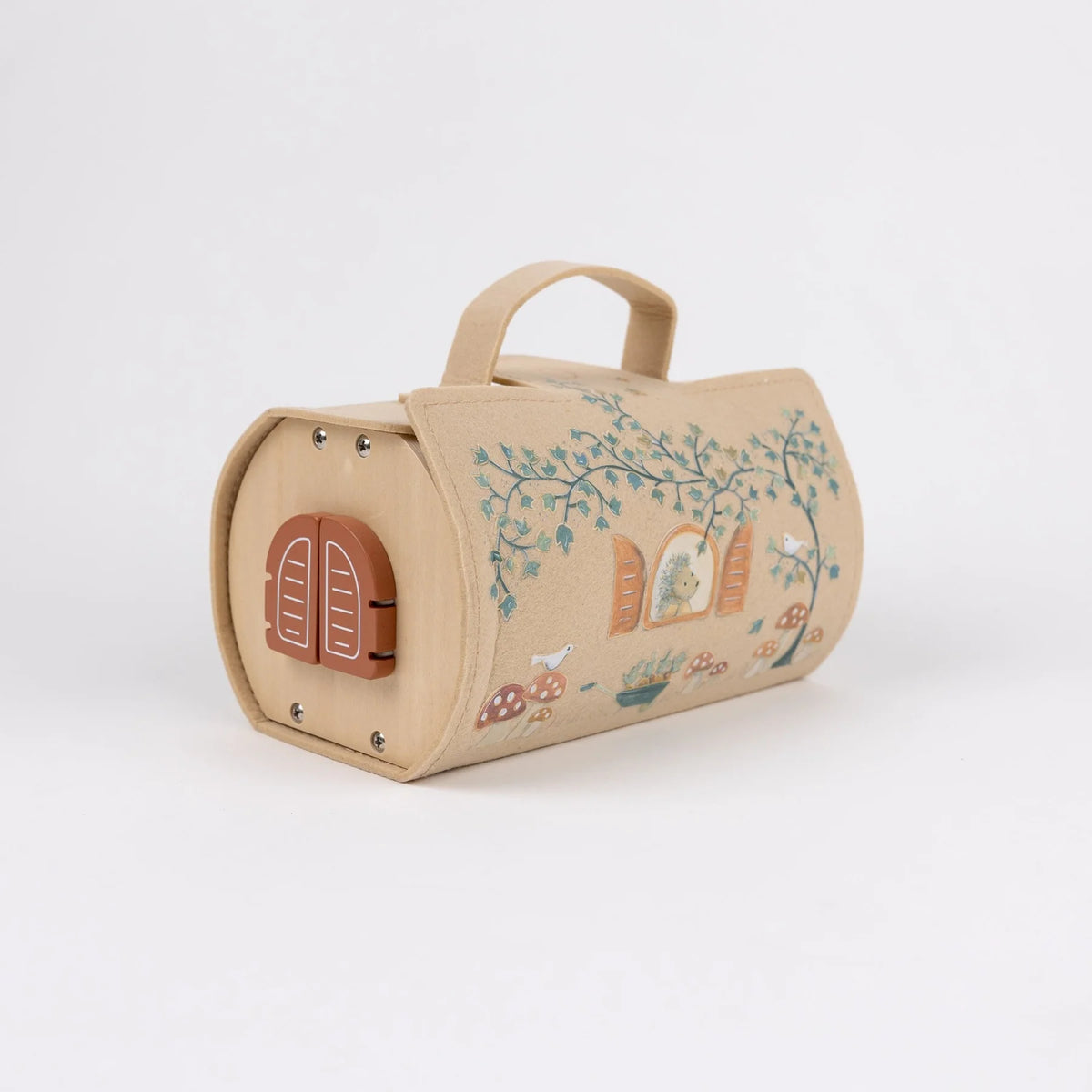 A small play house decorated with whimsical woodland illustrations including a house, trees, mushrooms, and a rabbit. It features a top handle and a reddish-brown latch closure on the front, photographed on a clean white background.