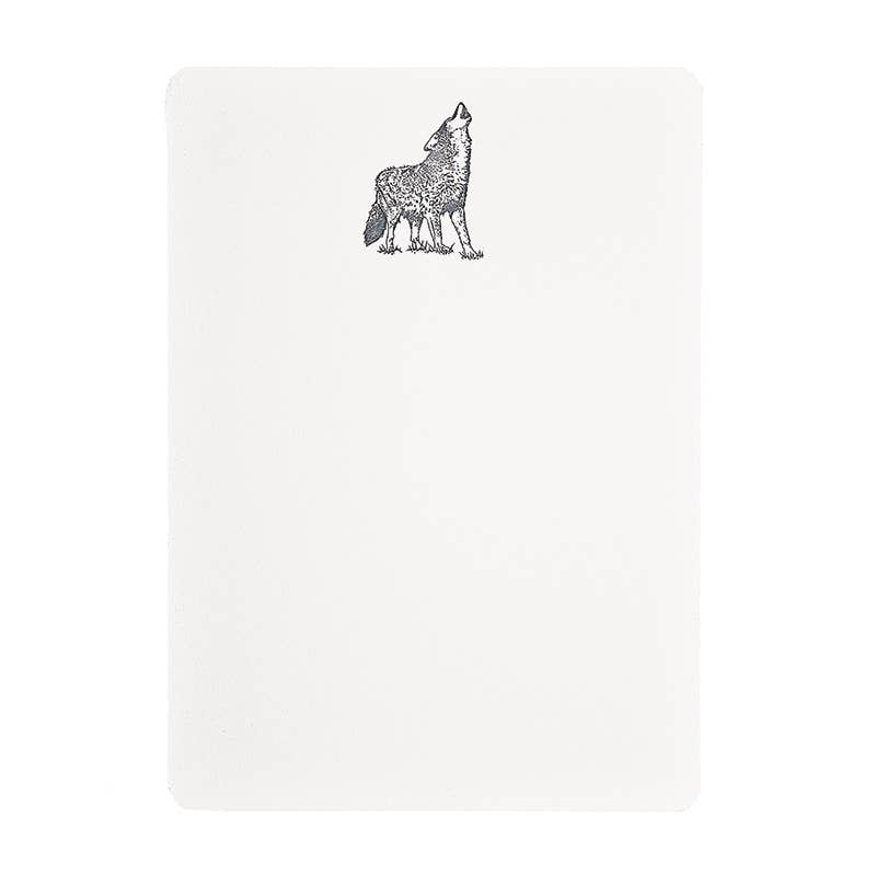 A white rectangular notebook or journal with rounded corners, featuring a black line art illustration of a howling wolf near the top center.