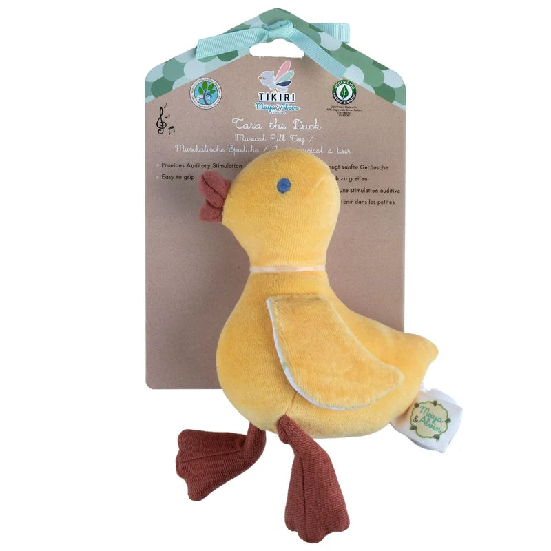A yellow plush duck toy with brown feet and beak, attached to its original cardboard packaging card by a mint green ribbon. The brand 'Tikiri Naturals' is visible on the packaging.