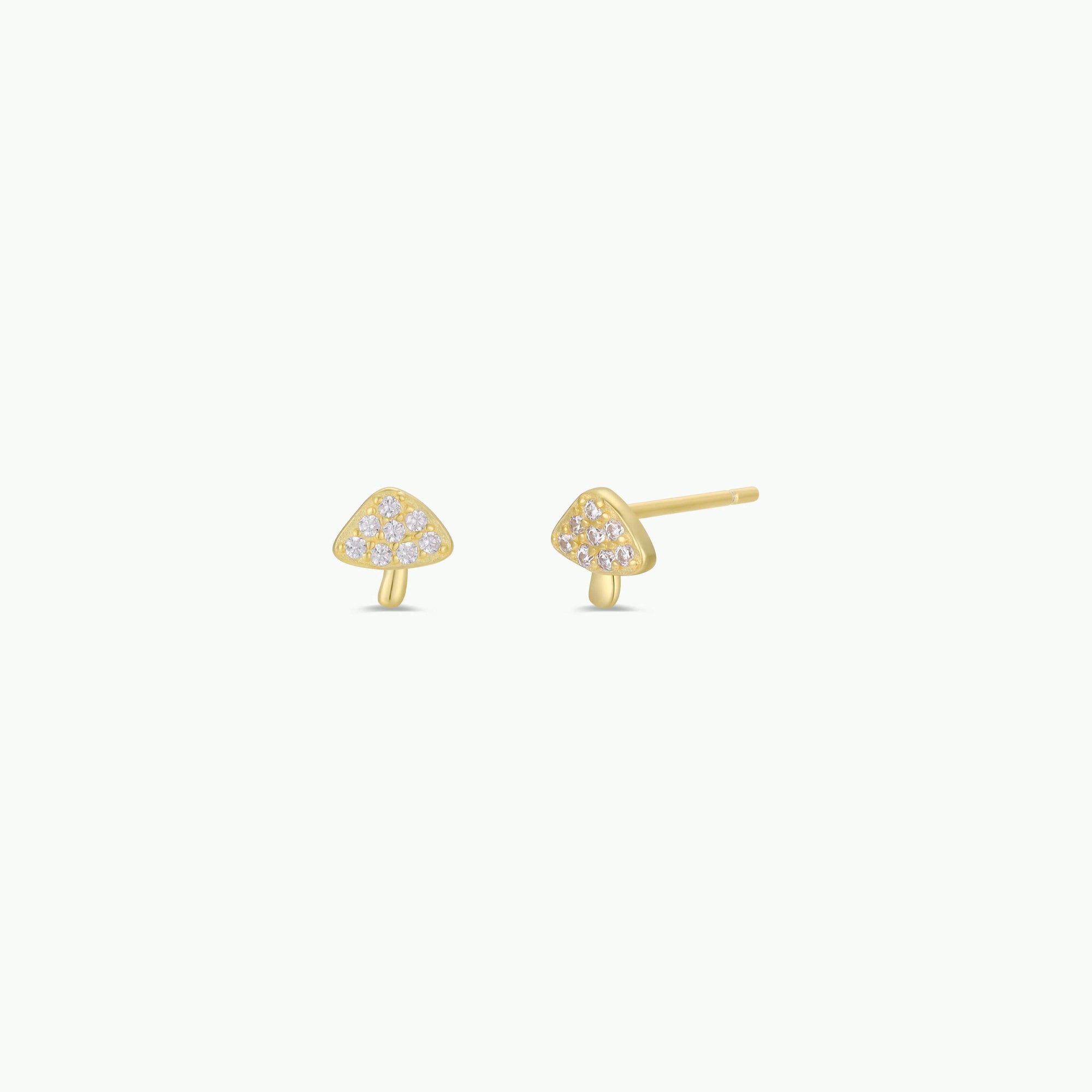 Gold mushroom-shaped earrings on a white background