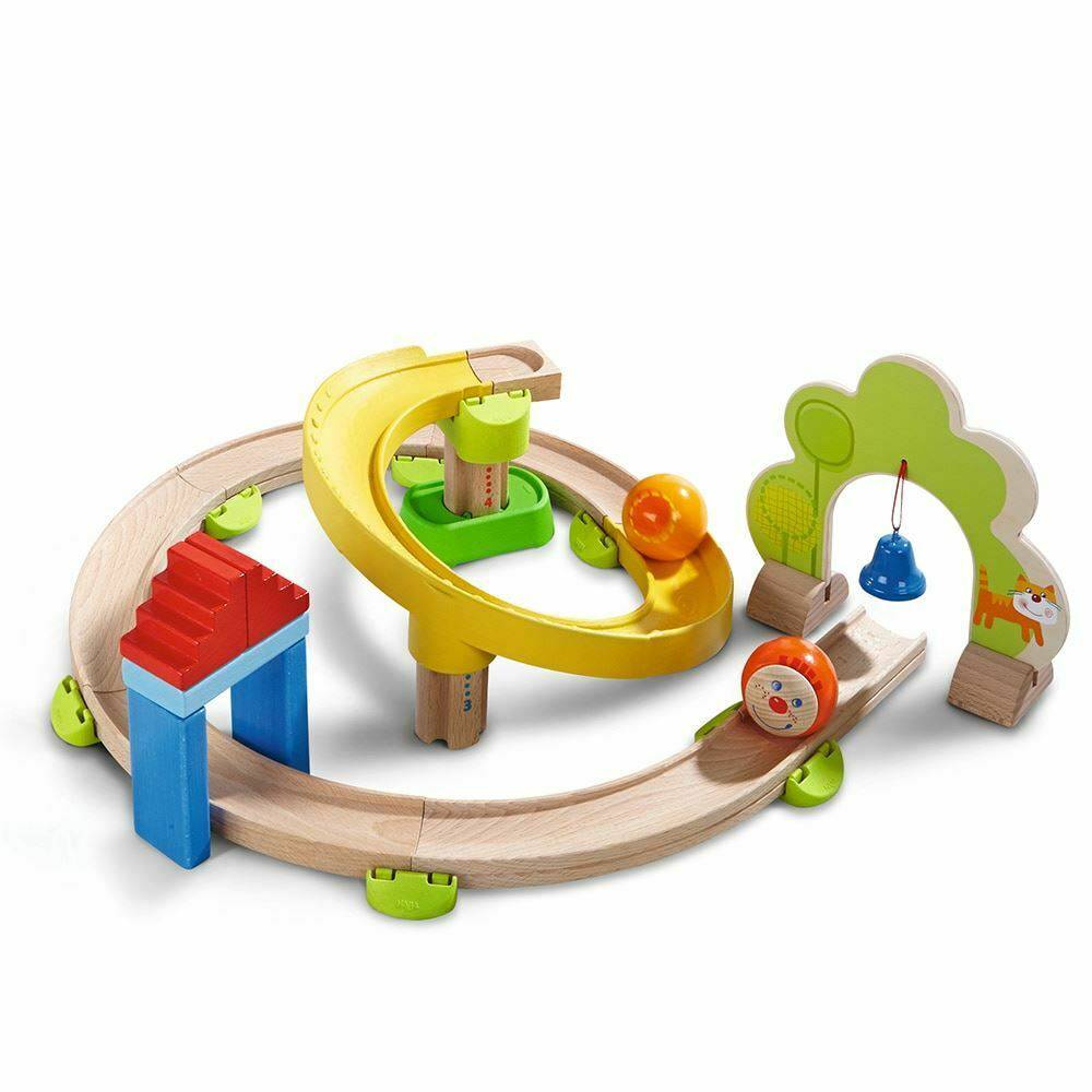 Colorful wooden toy train set with tracks and small cars on a white background