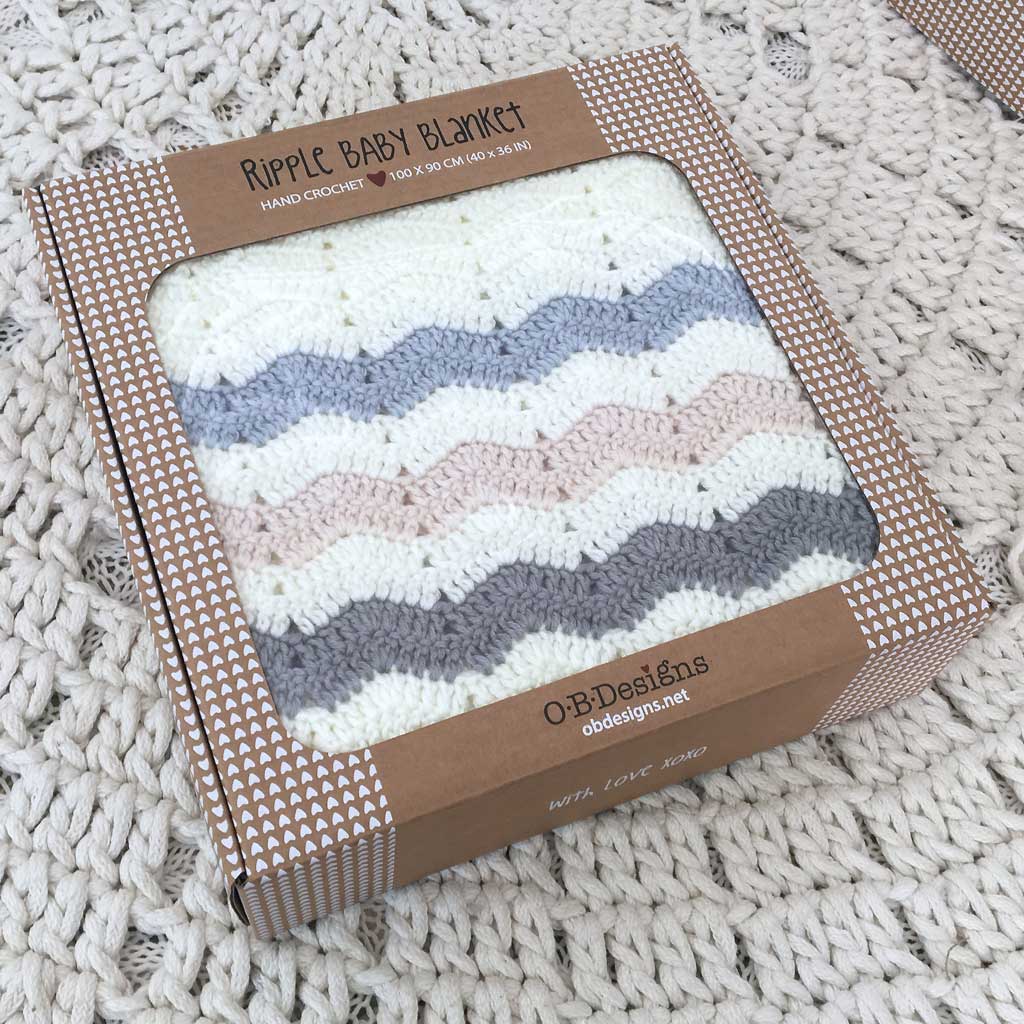 Ripple baby blanket in packaging on a textured surface