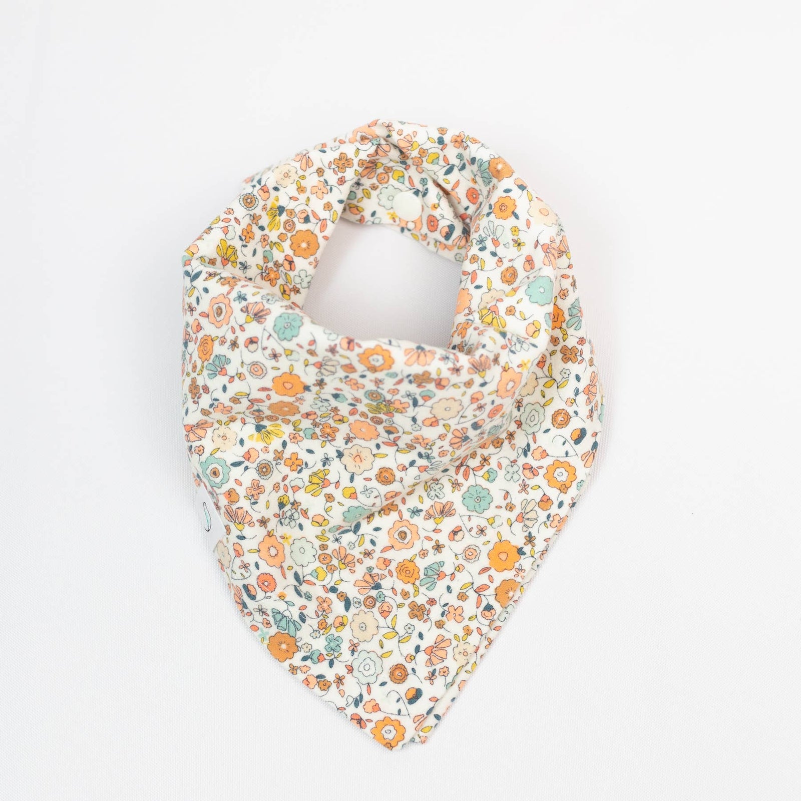 Floral patterned baby bib on a white background