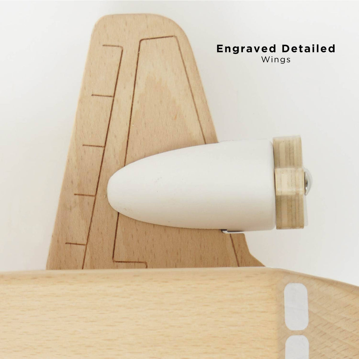 Wooden airplane model with engraved details on a white background