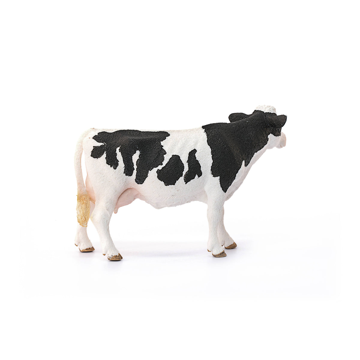 Black and white cow figurine on a white background