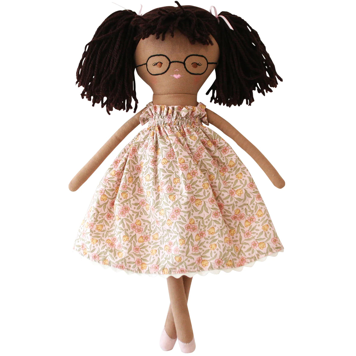 doll with glasses and brown hair ponytails in floral dress