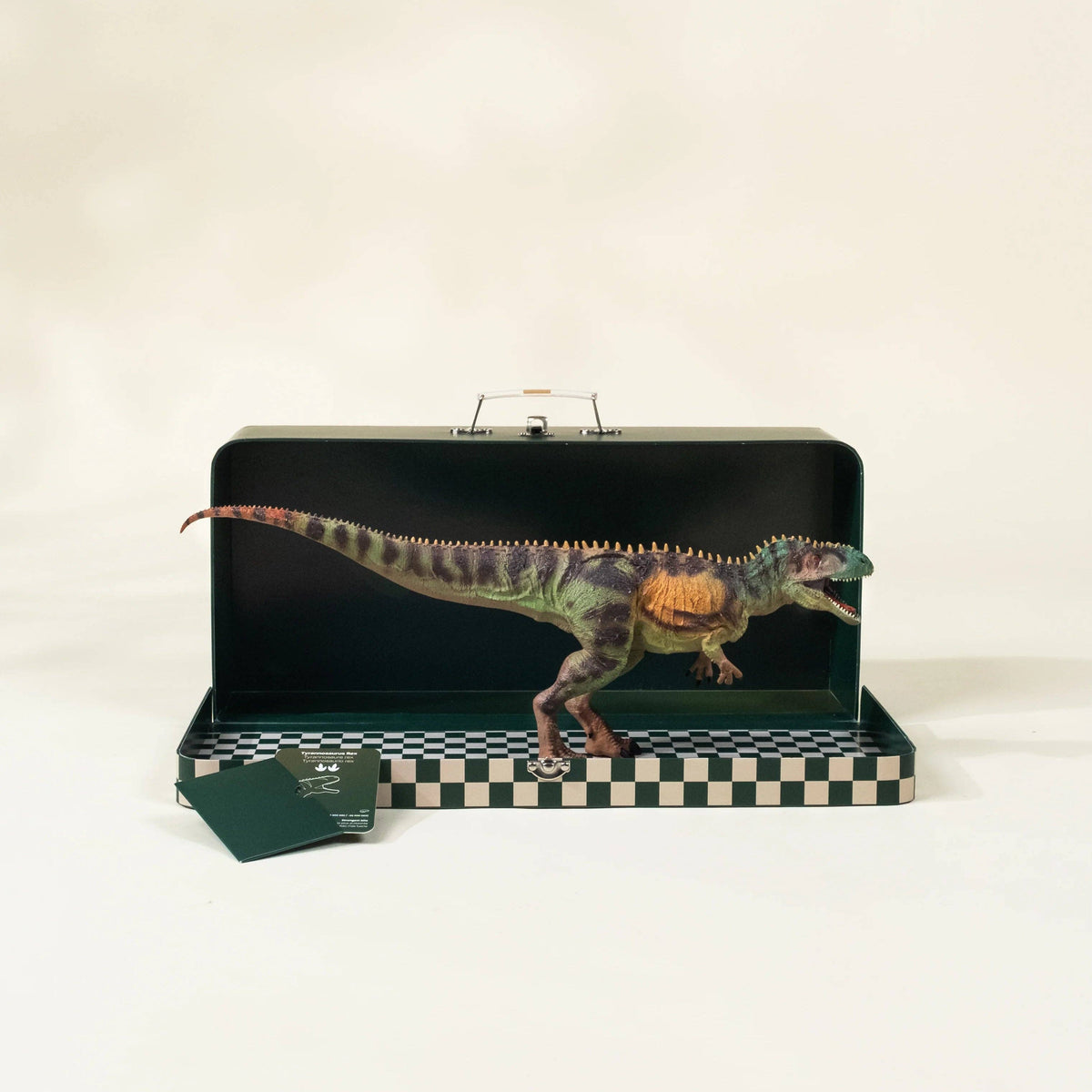 Dinosaur model inside a black case with a checkered base on a white background