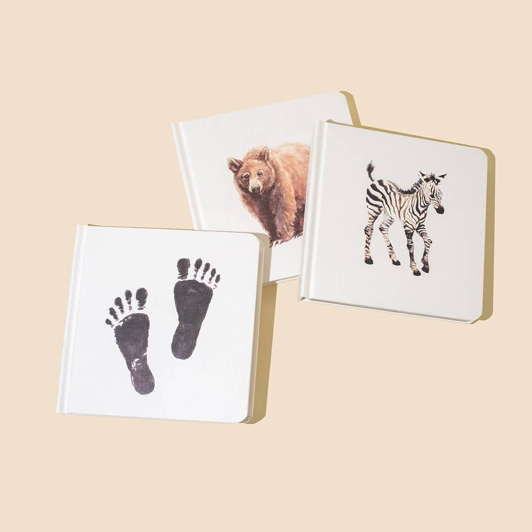 Three small books with animal illustrations on a beige background