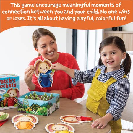 Woman and child playing with a board game together, smiling.