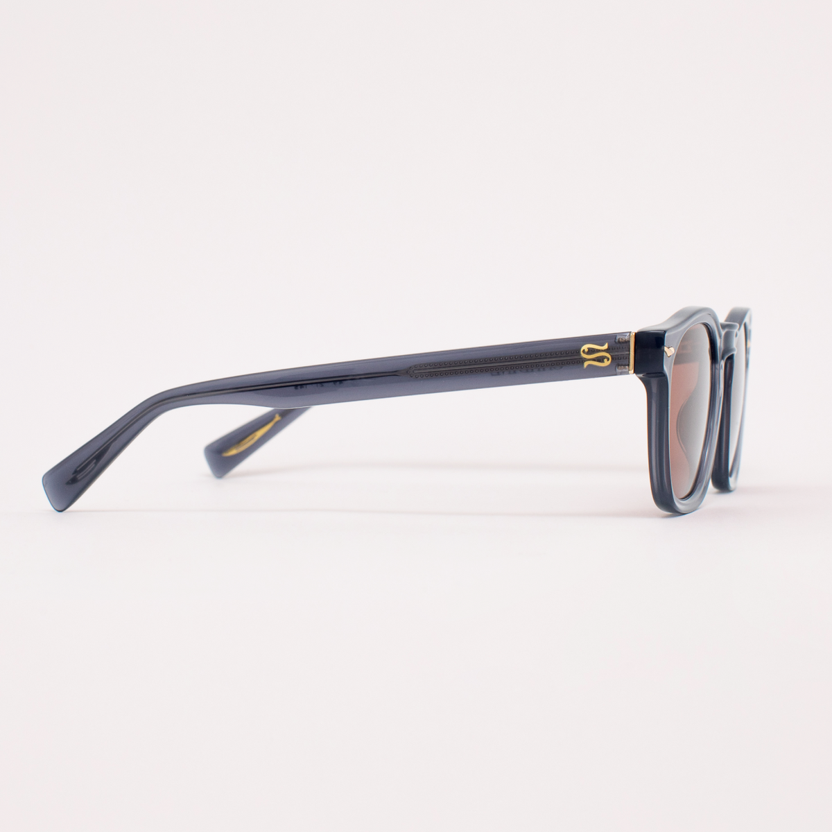 Sunglasses with a gold logo on a white background