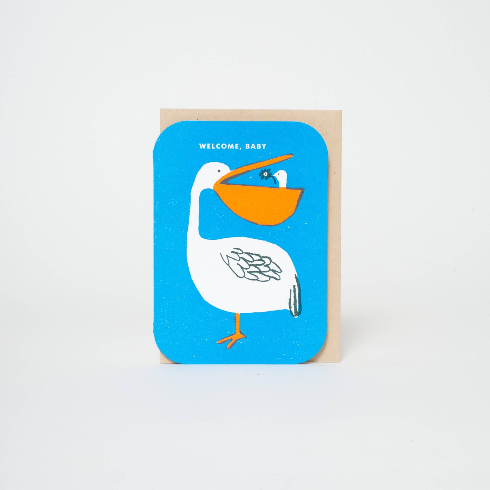 Greeting card with a pelican illustration and 'Welcome, Baby' text on a blue background.