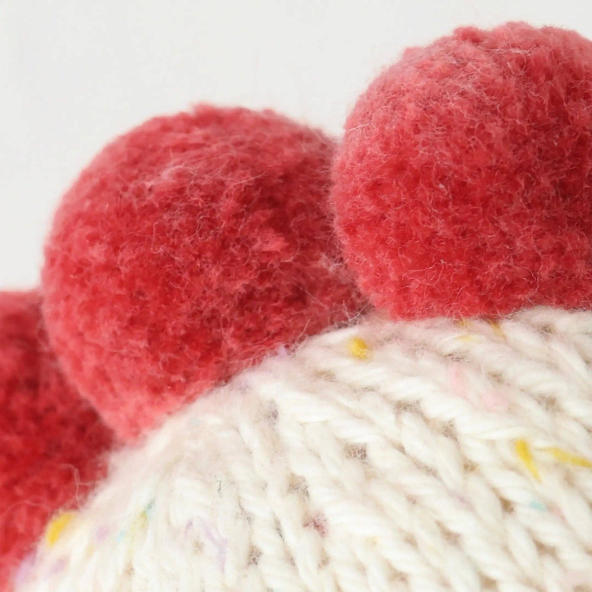 Close-up of red and white yarn balls with visible texture