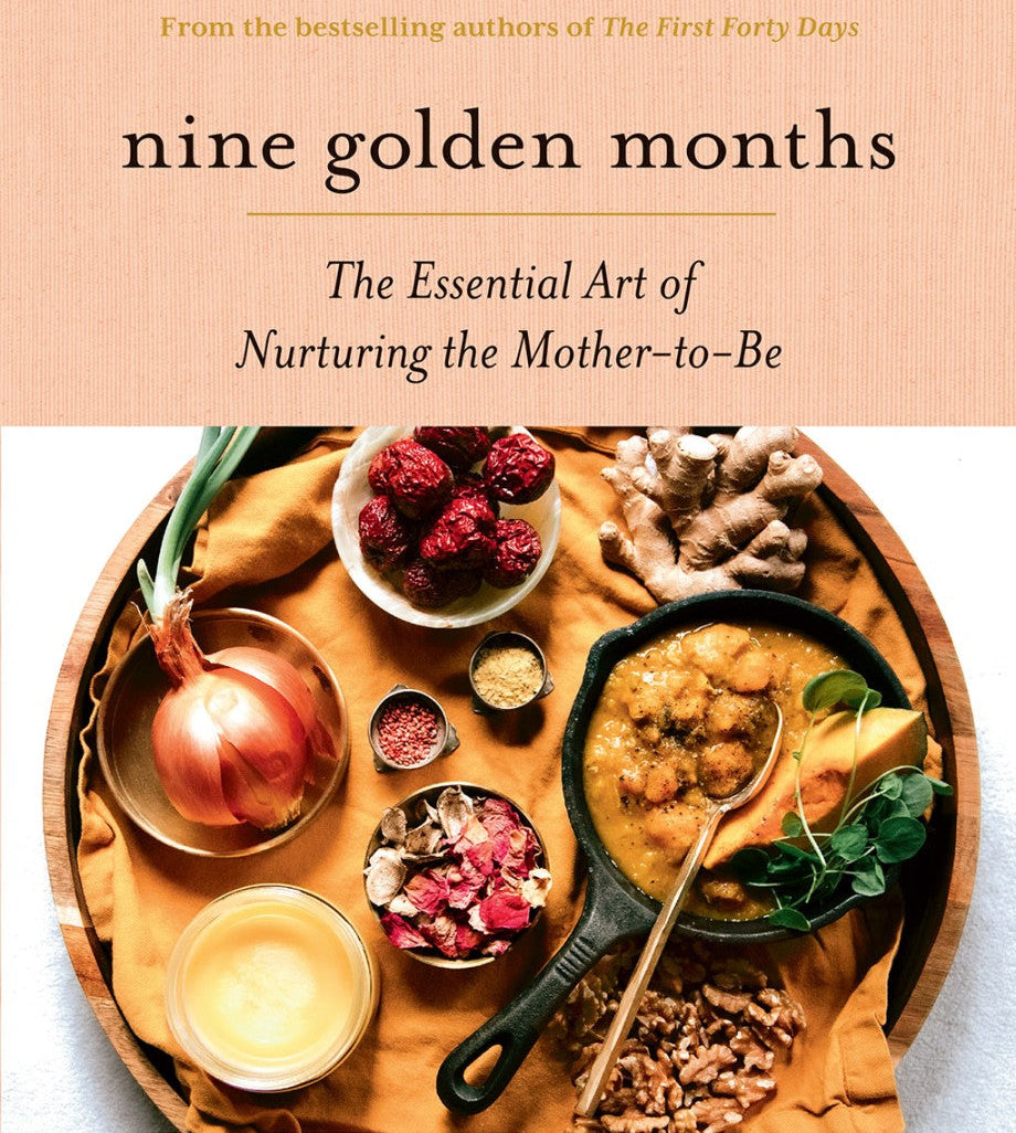 Book cover of 'Nine Golden Months' with a wooden tray of food and a candle on a beige background.