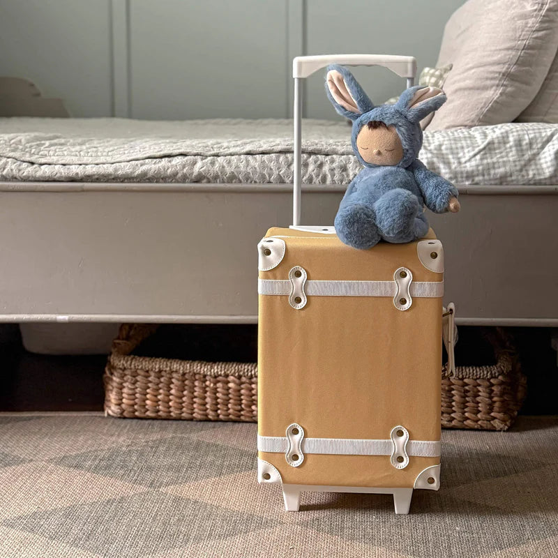 Blue plush toy with bunny ears on a textured beige blanket