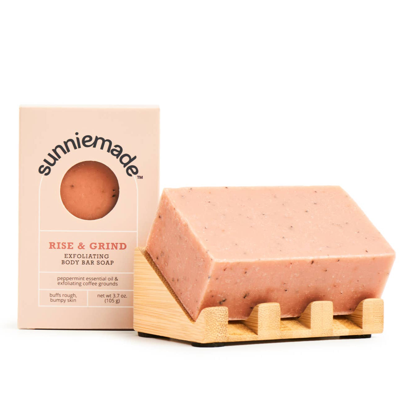 Pink exfoliating soap bar on a wooden stand with 'sunniemade' packaging in the background.