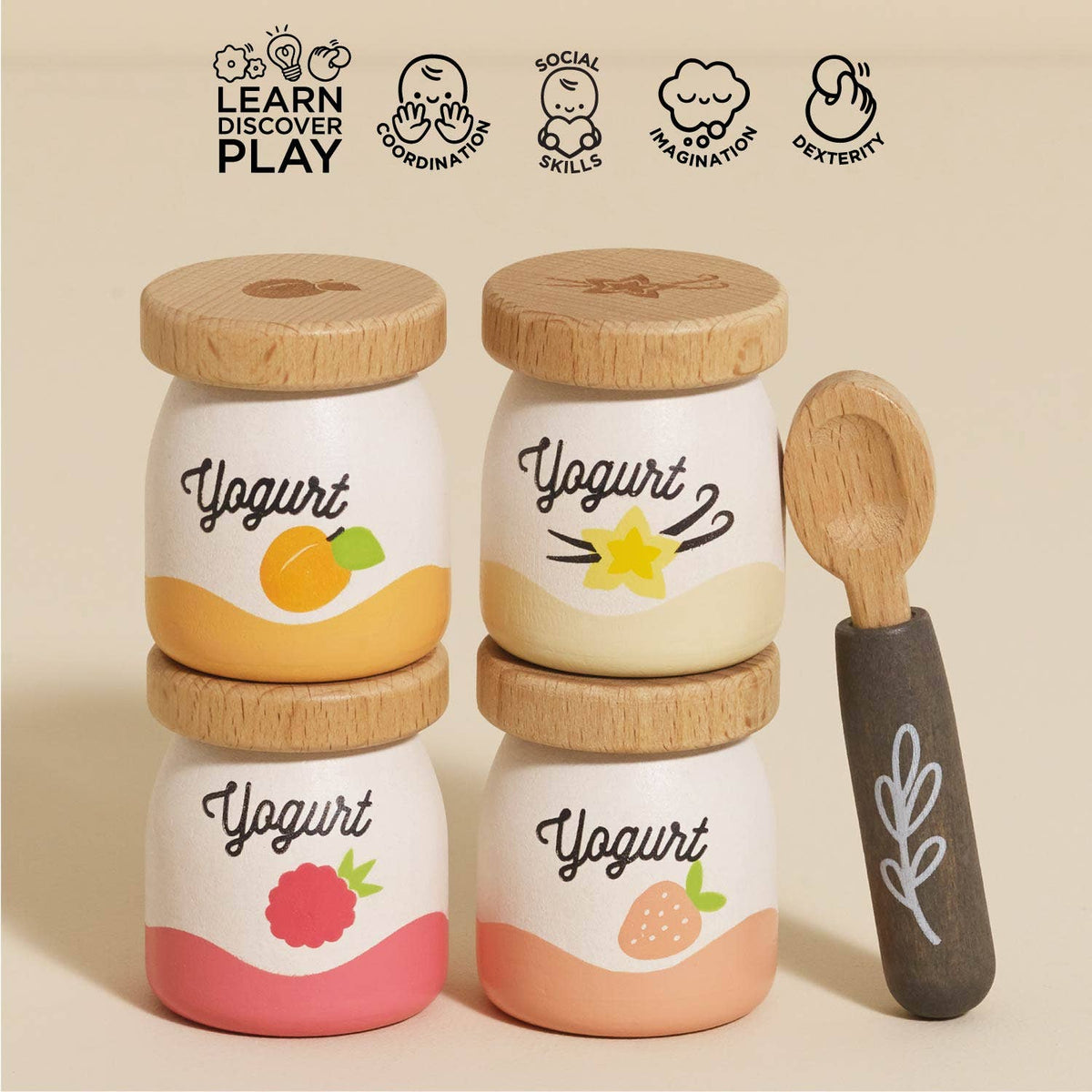Set of four yogurt jars with wooden lids and a spoon on a beige background, featuring icons and text about learning, discovery, and play.