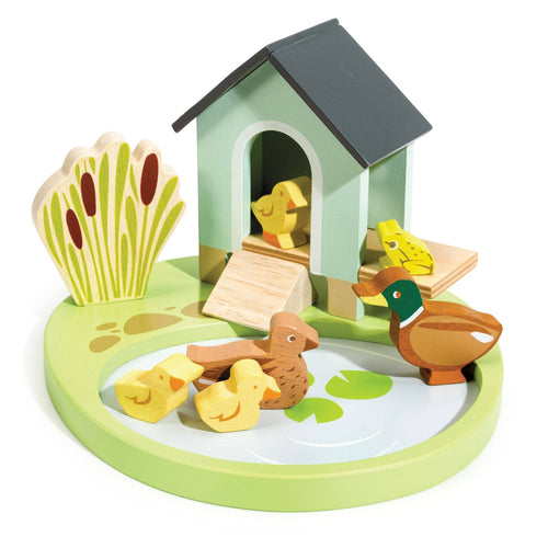 Wooden toy set with ducks, ducklings, and a duck house on a white background