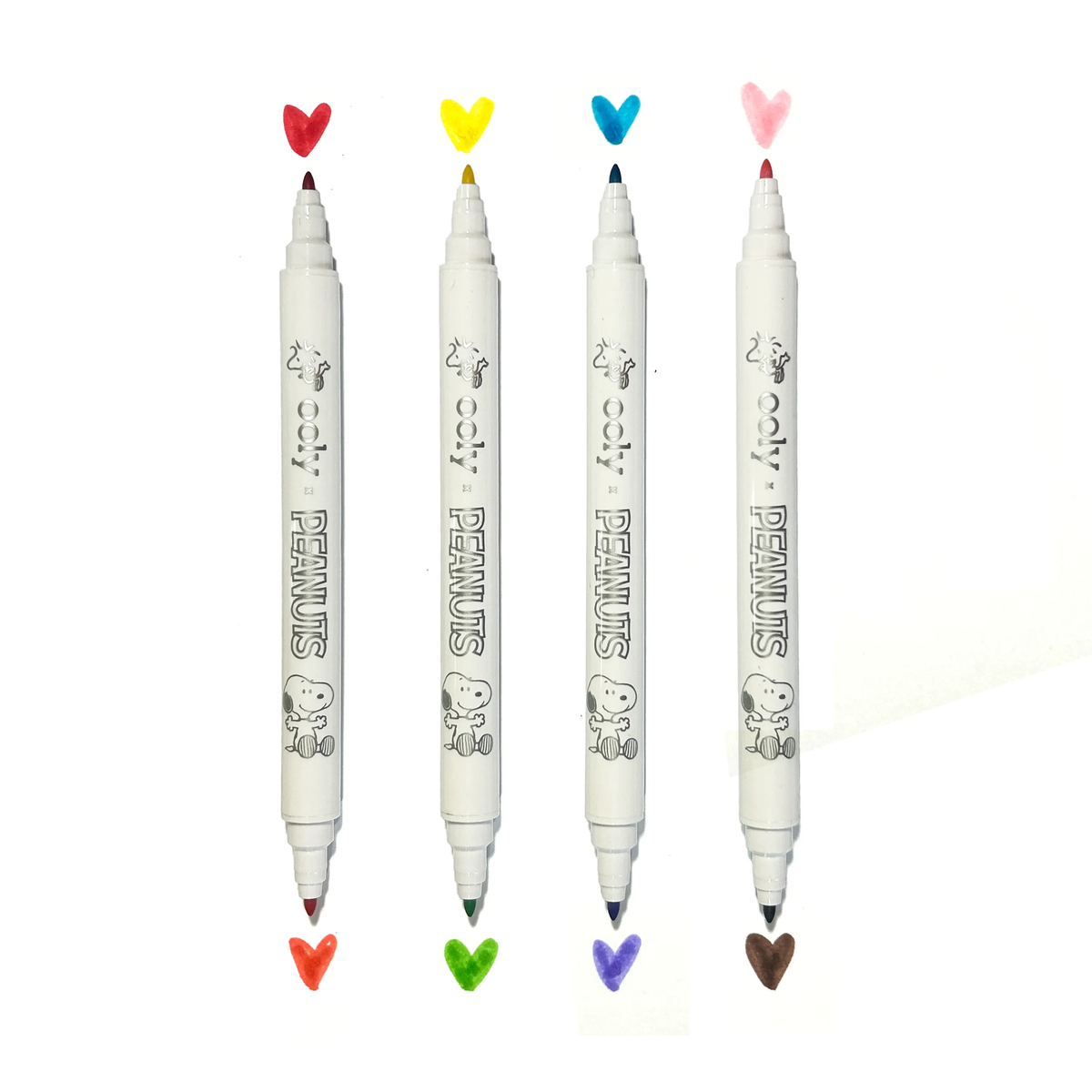 Four white markers with colorful heart-shaped caps on a white background