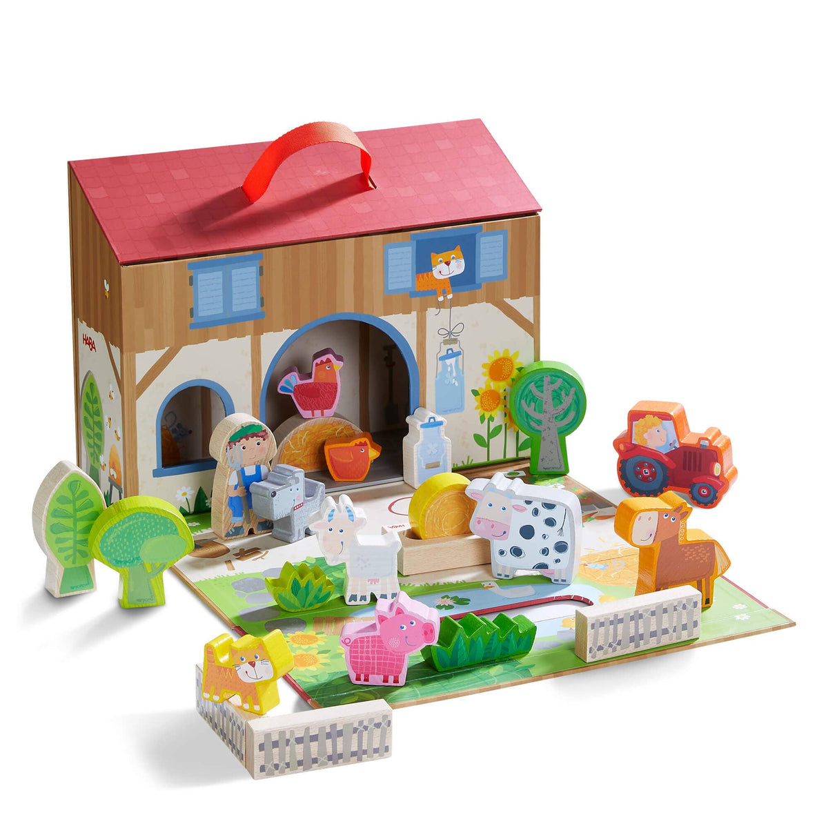Toy farm set with animals and a barn in a cardboard box on a white background