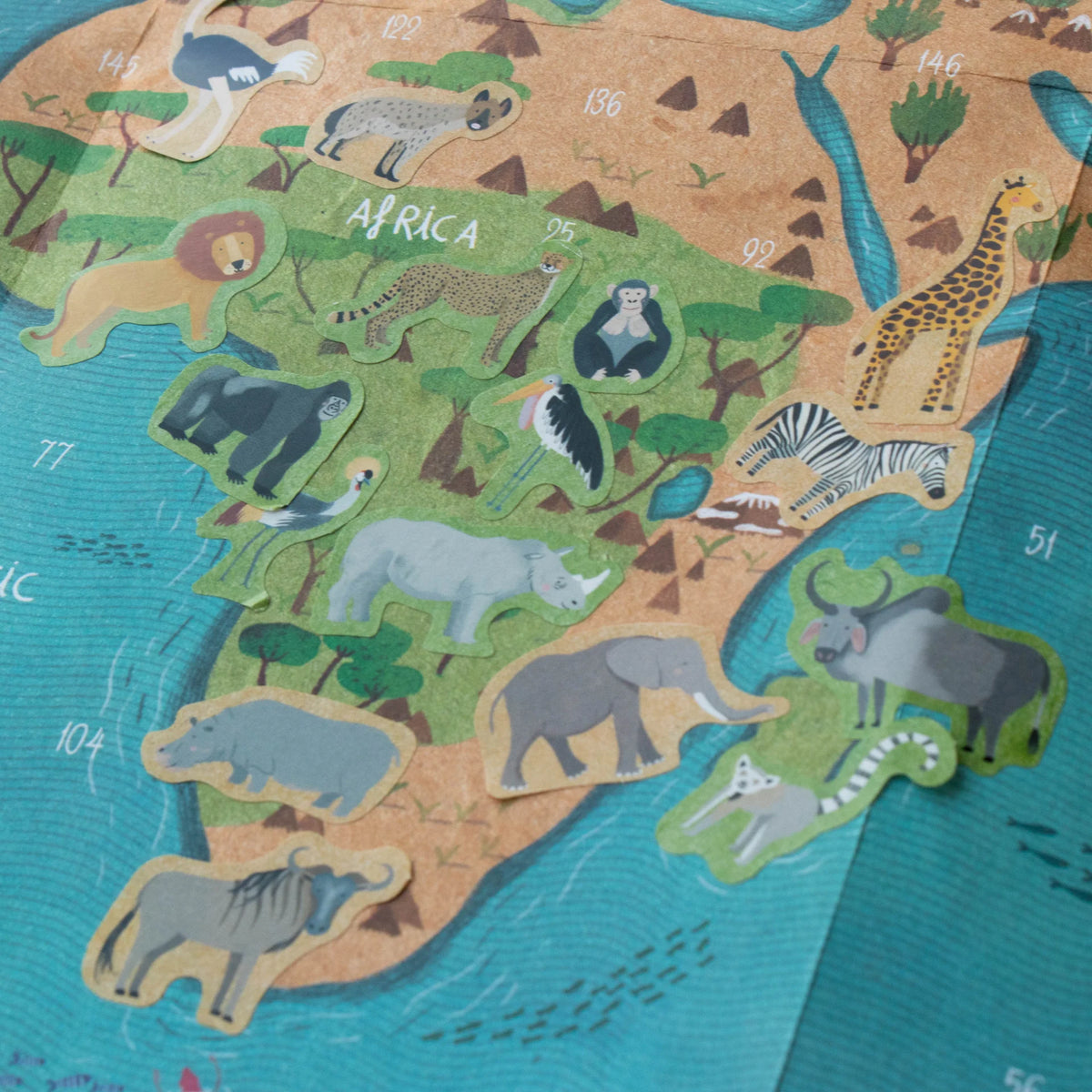 Map of Africa with animal illustrations on a textured surface