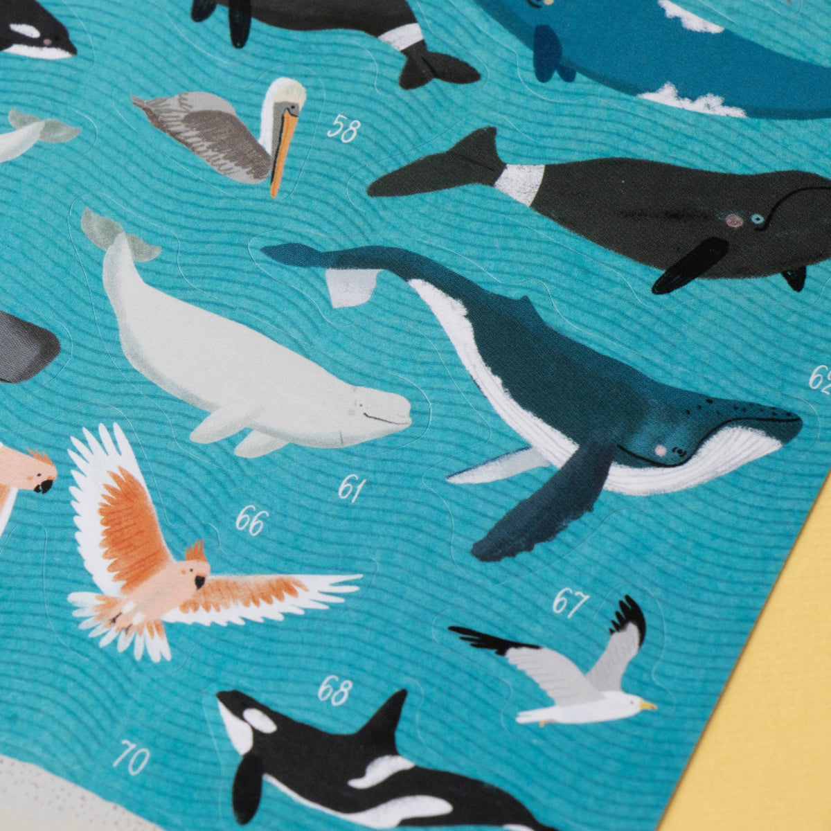 Pattern of whales, birds, and other sea creatures on a blue background