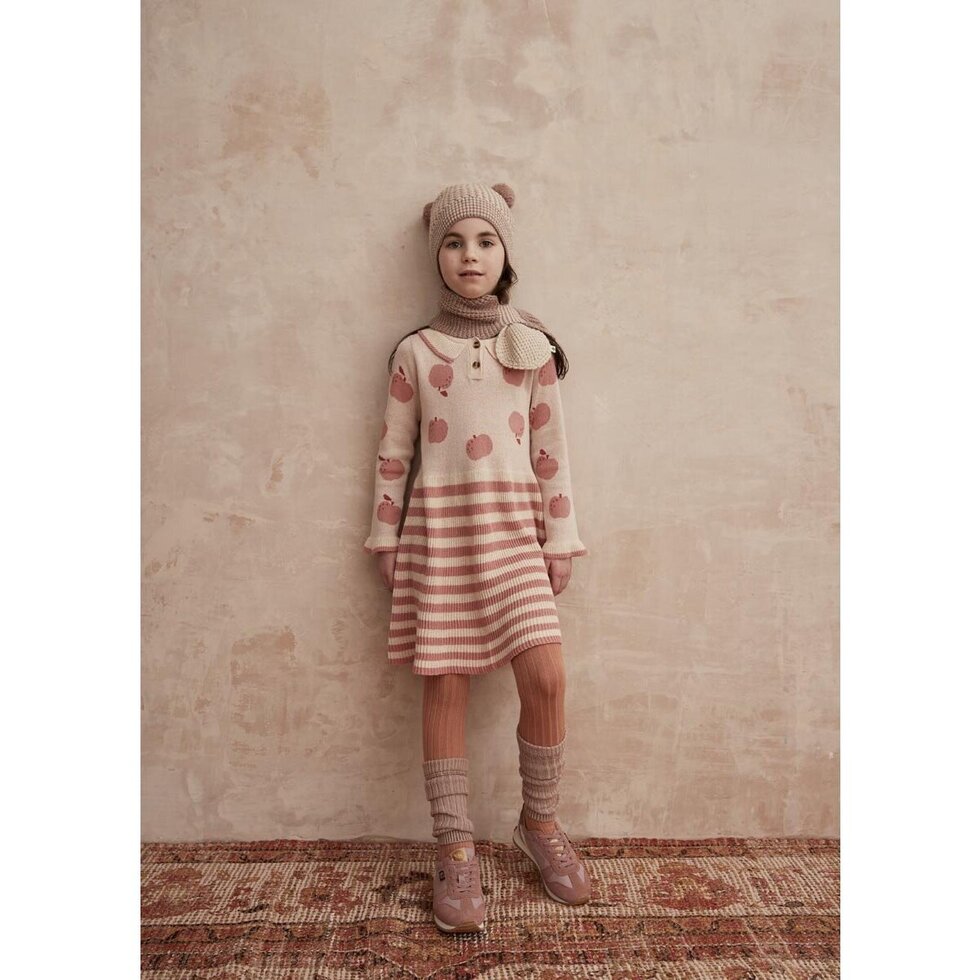 Children's dress with pink apple pattern and striped skirt on a white background