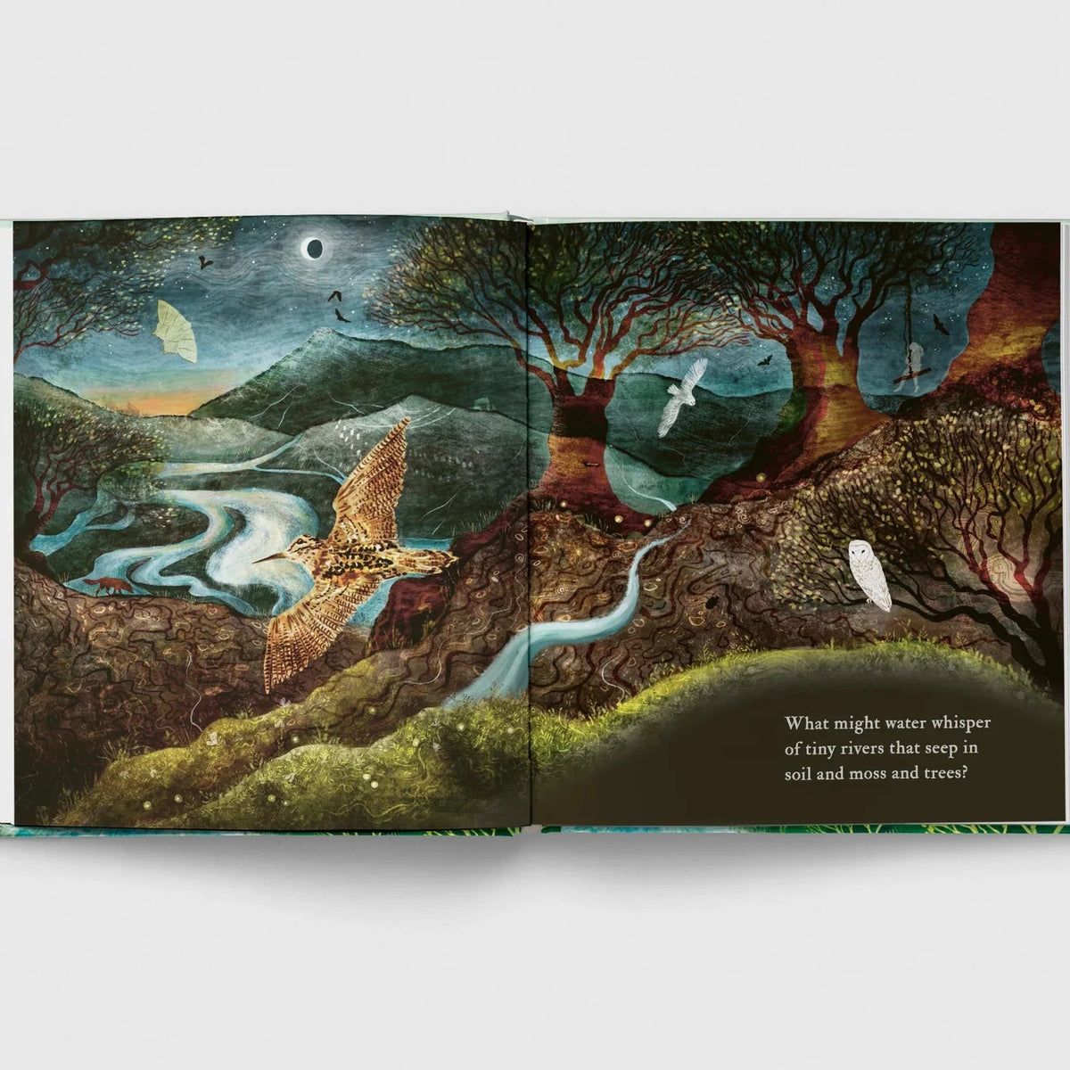 Open book with a fantasy landscape illustration on a white background