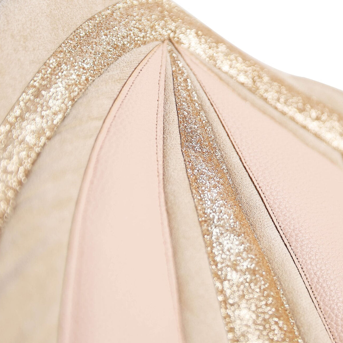 Close-up of a pale pink costume with gold accents on a white background