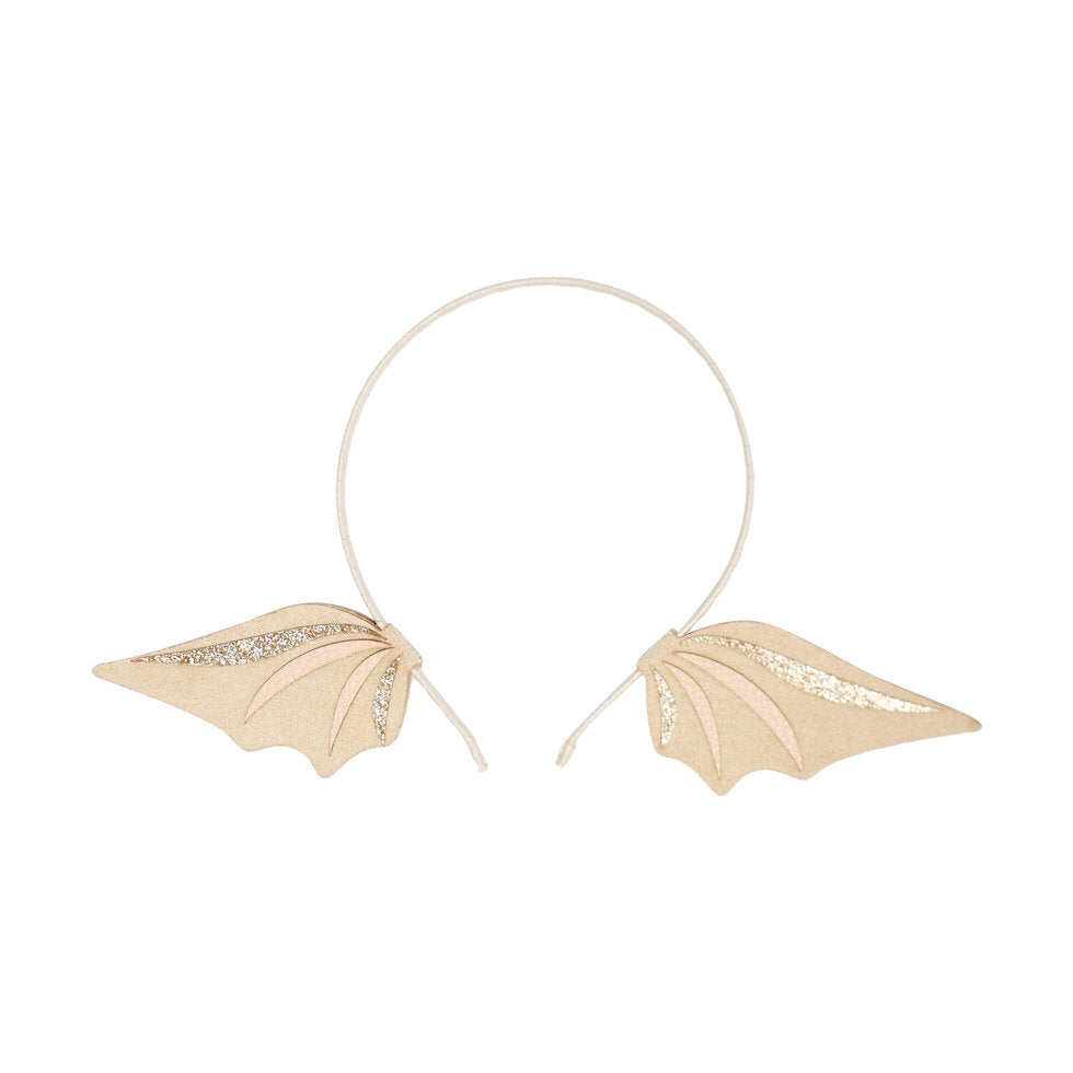 A headband with two small dragaon-wing shaped side decorations in pale pink and beige, accented with glittery gold stripes, on a plain white background.