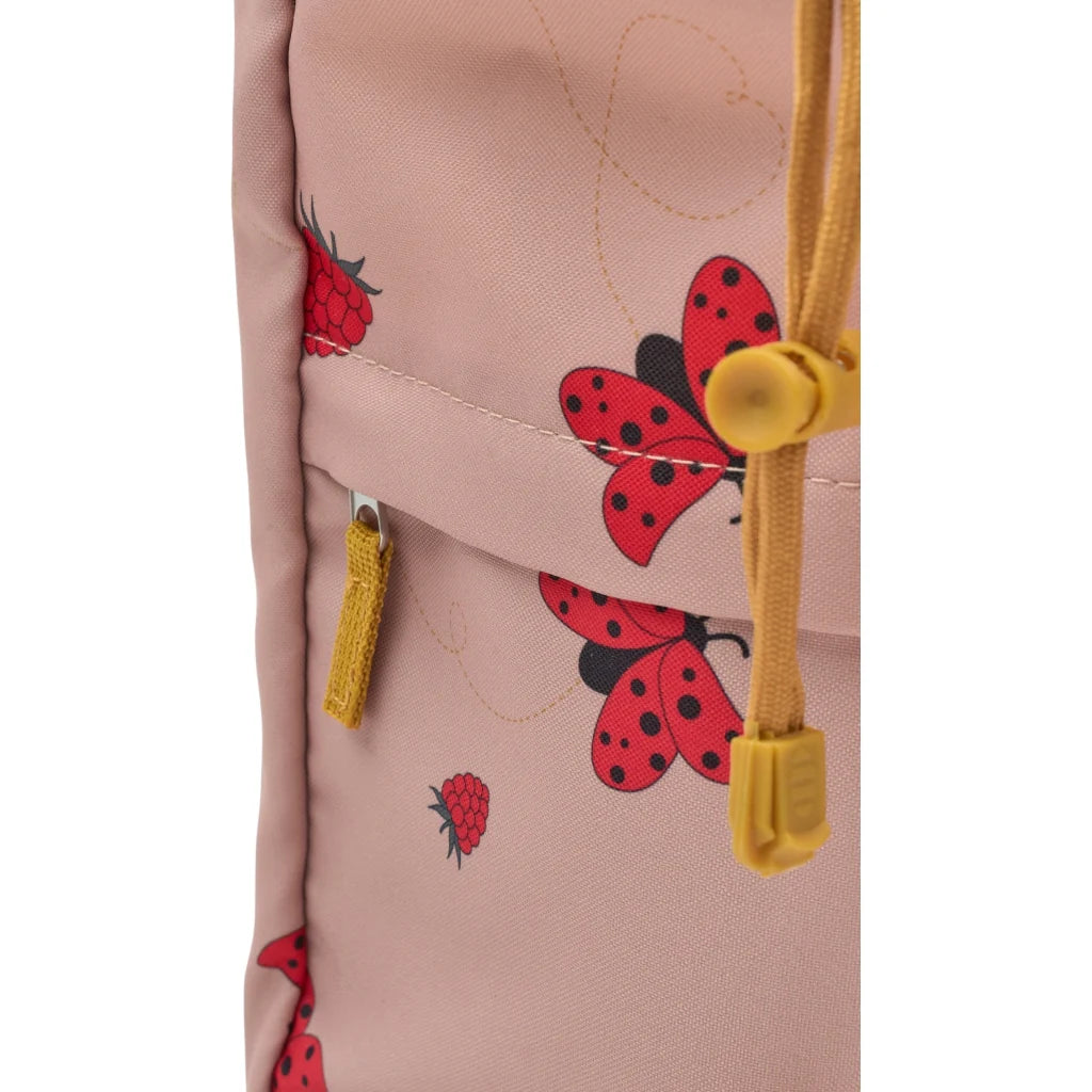 Pink backpack with ladybug patterns and yellow drawstrings on a white background