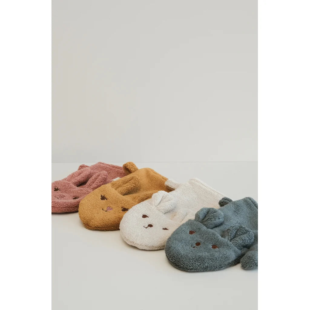 Four pairs of animal-shaped bath mitts in pink, brown, white, and blue on a light gray background.