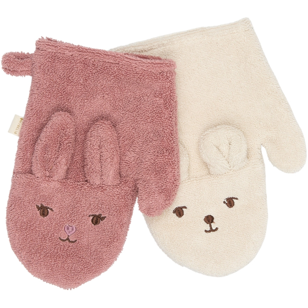 Two bath mittens with bunny face designs, one pink and one beige, on a white background.