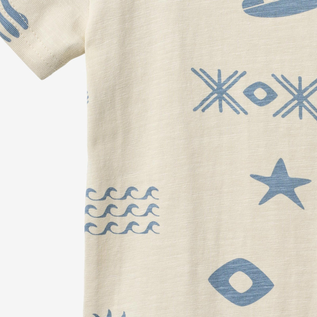 Beige fabric with blue geometric patterns including stars and waves.