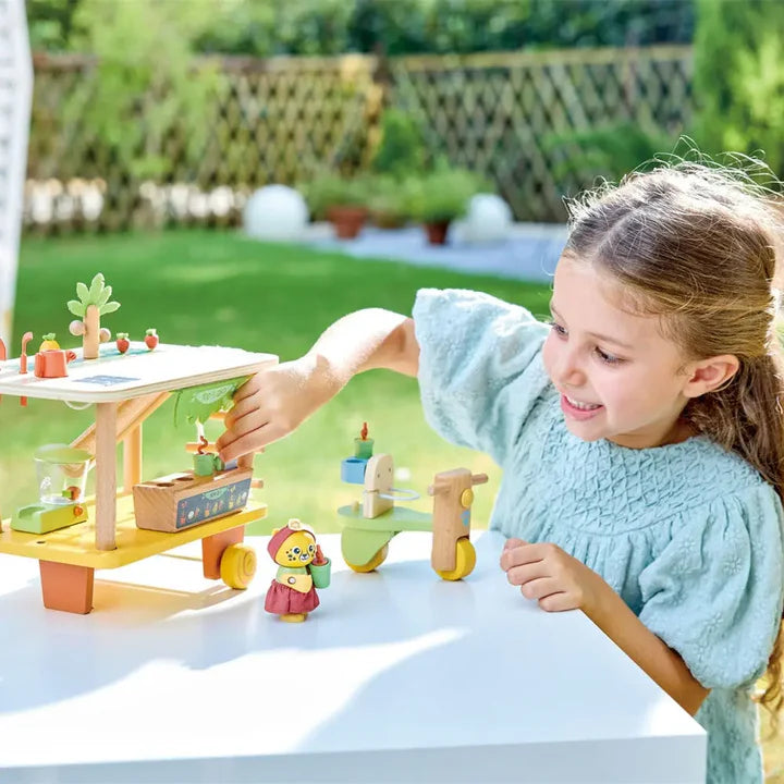 Child playing with a wooden toy set outdoors