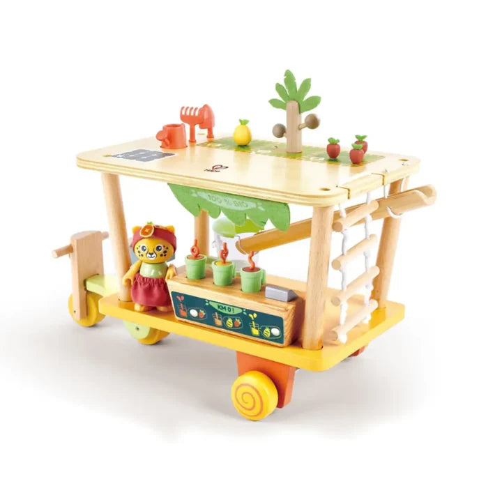 Wooden toy cart with various accessories on a white background