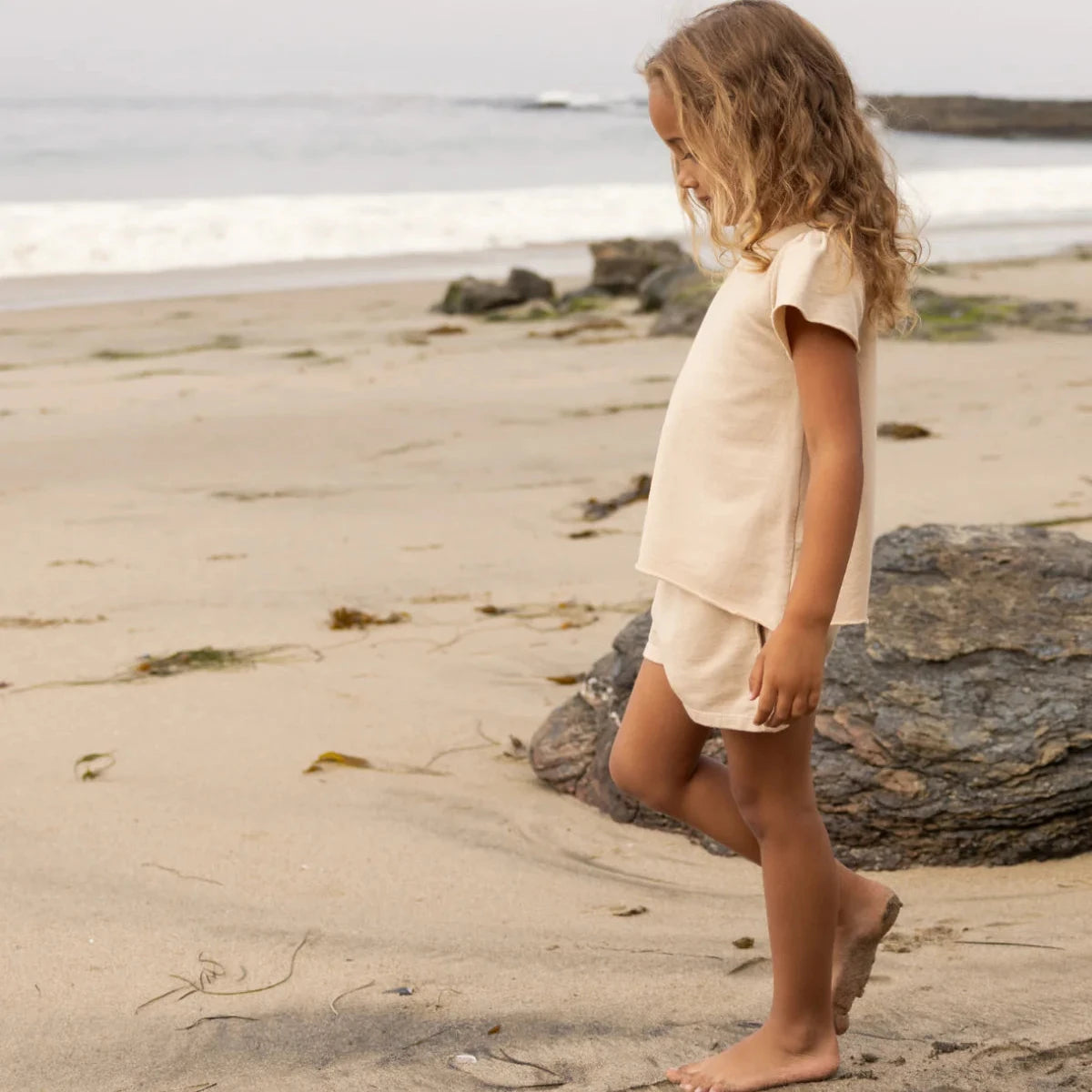 Beige shorts and top set on a neutral background