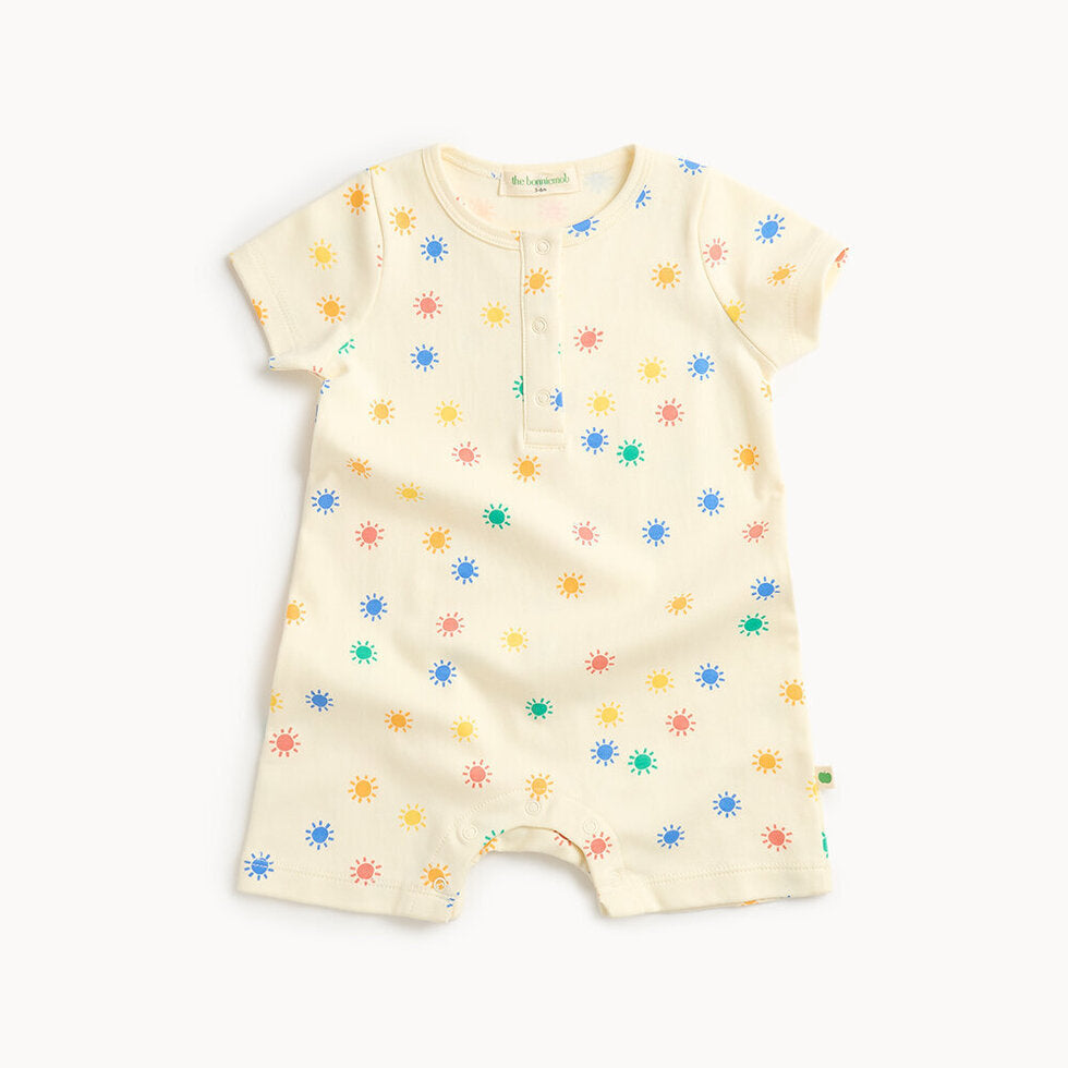 Baby romper with colorful sun pattern on a white background