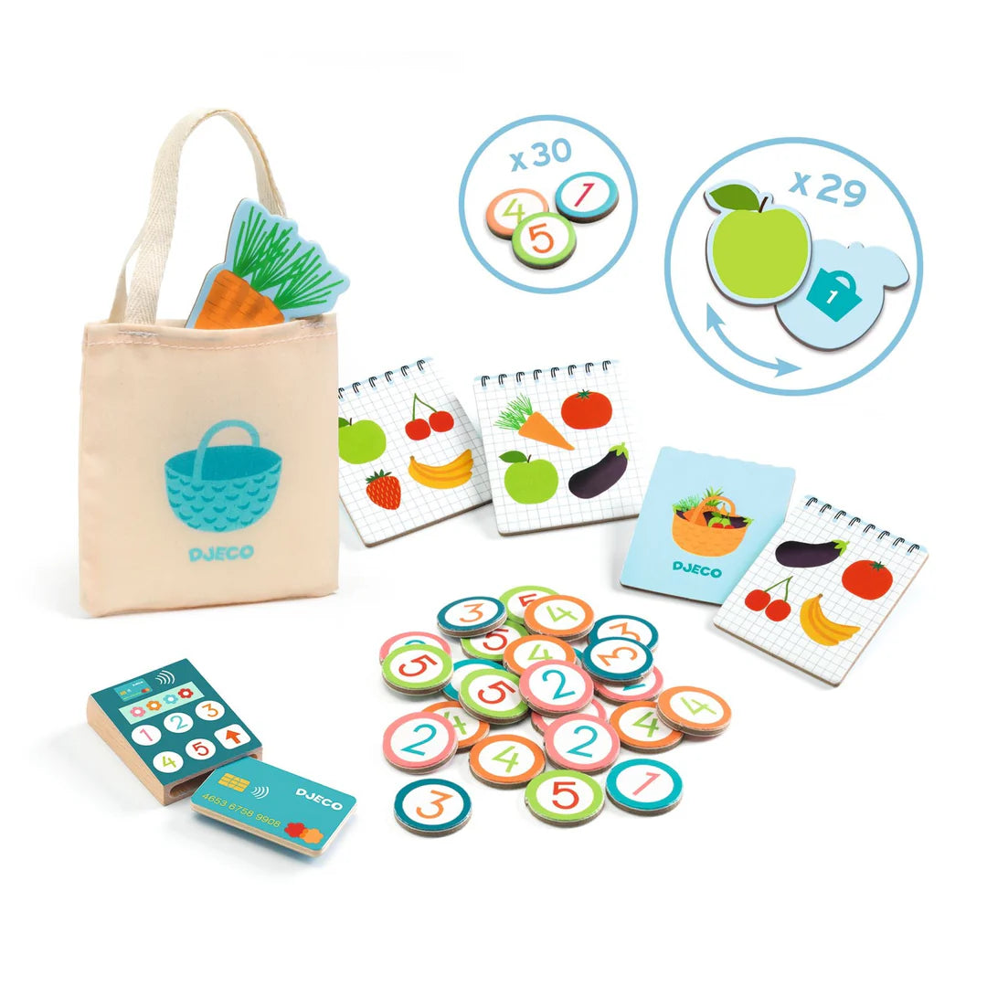 Toy grocery store set with fruits, vegetables, and cash register on a white background