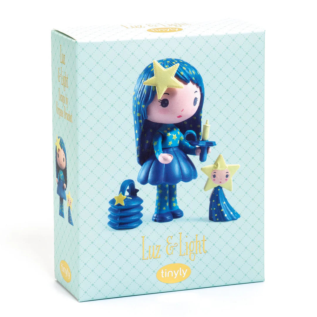 Toy figure with blue hair and dress, holding a star-shaped object on a white background
