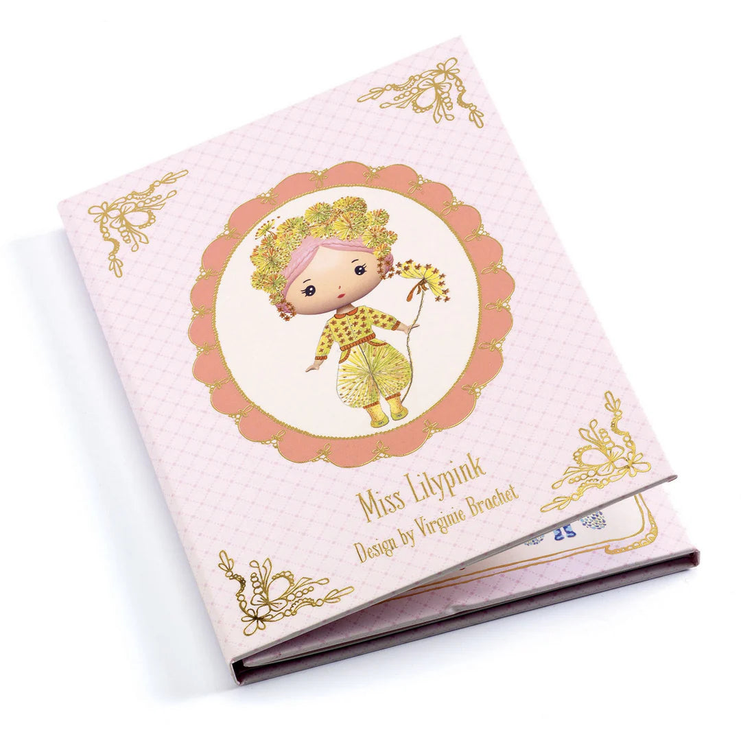 Book with a decorative cover featuring a cartoon character on a pink background